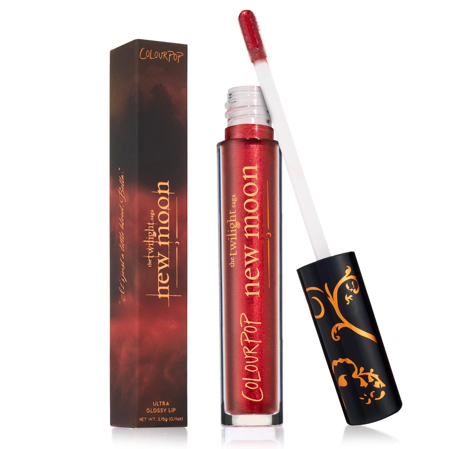 ColourPop Ultra Glossy Lip in Runs with Vampires glides on a doe-foot applicator with deep ruby red shimmer, shown open beside a Twilight Saga: New Moon–themed tube and box, black cap with gold filigree, delivering a high-shine, dramatic tint.