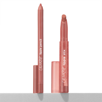 Perfect Duo ColourPop Lippie Stix + Pencil Set stands upright with caps off, the slim lip pencil and twist-up lippie stix revealing a warm rosy nude shade, displayed on a light surface against a white studio background.