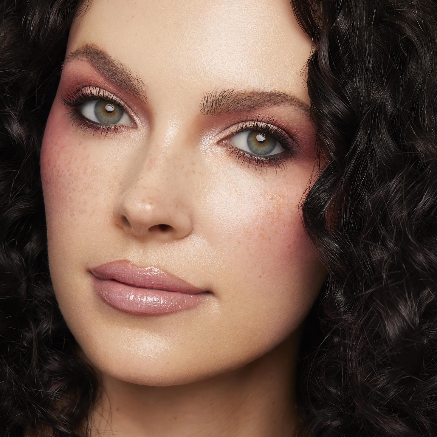 Model showcases rosy mauve eyes and flushed cheeks created with Baby Got Blush, a ColourPop Shadow Palette Set, with matte and shimmer shades blended on lids and lower lash line; studio close-up highlights soft pink tones and natural freckles.