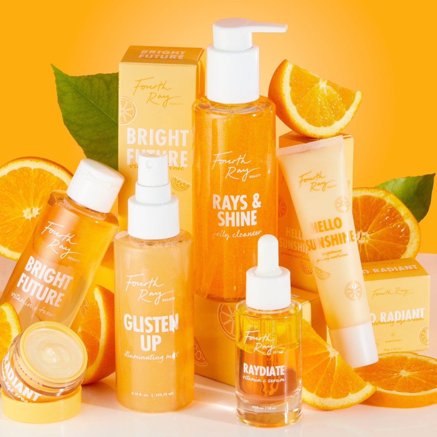 Colourful orange display of Colourpop Fourth Ray serums and Ego Boost serum stick standing among fresh orange slices on a bright citrus background, highlighting the vibrant skincare collection for glowing skin in the US.