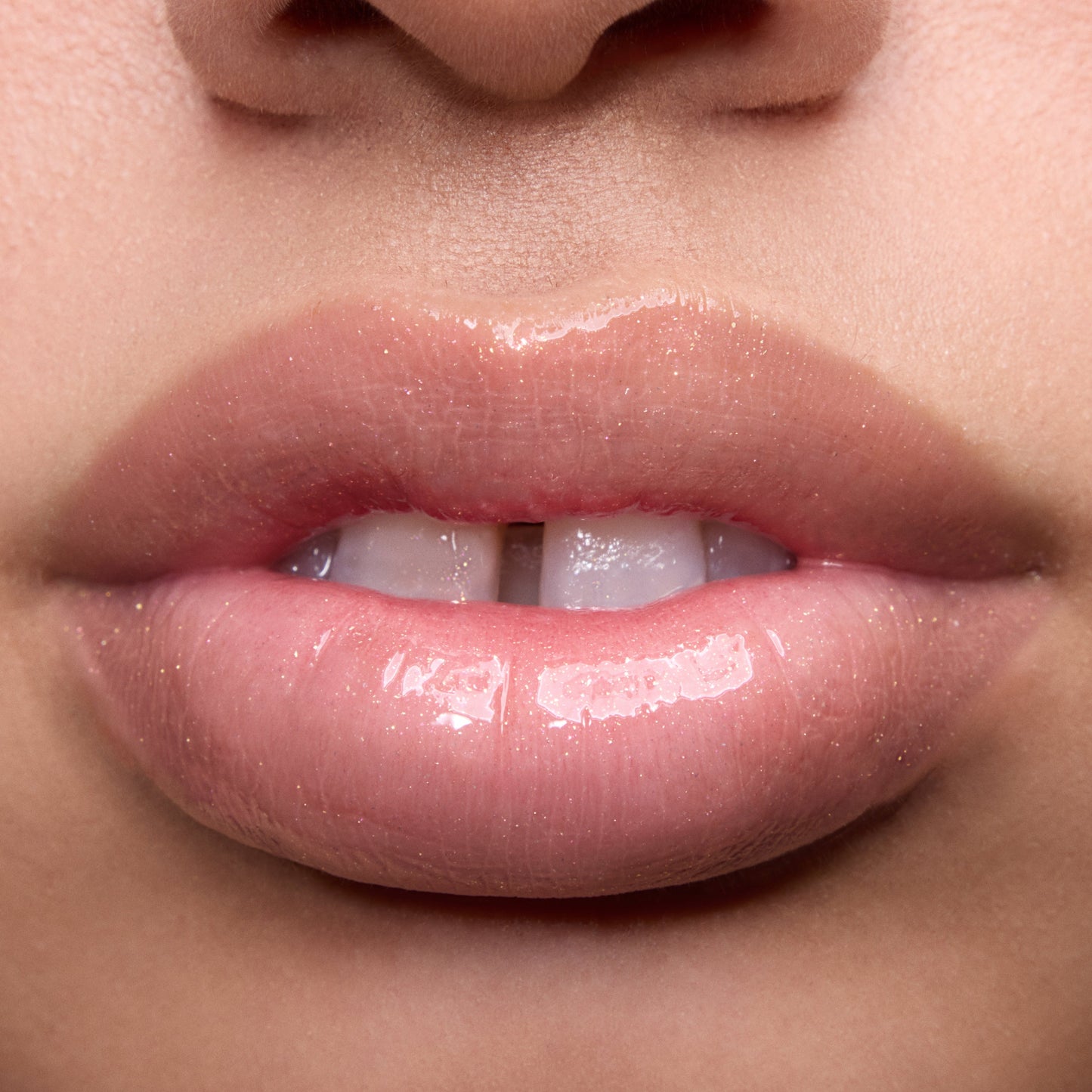 Close-up swatches of Colourpop Peach Mochi Fresh Kiss Glossy Balm on models’ lips, showing sheer peachy shimmer and high-shine finish, highlighting how this Lip Gloss & Lip Oil hybrid looks on different skin tones.