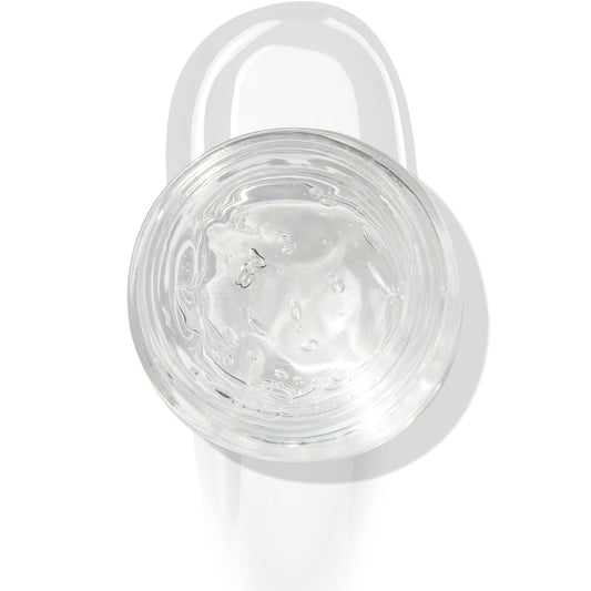 In The Clear Face & Eye Gloss in an open round jar gleams with a glossy swipe beneath it on a white background, showcasing the ColourPop Face & Eye Gloss for dewy, glass-skin shine on lids and cheeks.
