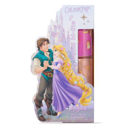 ColourPop Liquid Highlighter I See the Light tube displayed upright in Disney Tangled Rapunzel packaging with Flynn Rider, featuring a pink lantern-print cap and a clear bottle showing a sparkly champagne-gold dewy formula for a radiant glow.