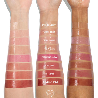 ColourPop So Juicy Plumping Glossy Lip Oil swatches across three arms (light to deep), with shade names labeled; focus on Hits Diff - a warm rosy gloss - positioned between So Sassy and Beverly Drive for easy shade comparison on varied skin tones.