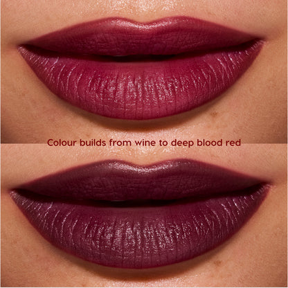 Close-up lips wearing Newborn powder to creme lipstick from the Twilight collection, showing buildable color shifting from rich wine to deep blood-red with a smooth, satin finish on medium skin tone.