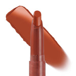 Ziggie Lippie Stix by ColourPop standing upright with tip exposed, a warm terracotta-brown swatch swept behind to show creamy matte payoff on a white background; ColourPop Lippie Stix product close-up.